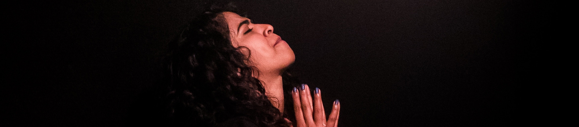 A women deep in prayer A women deep in prayer