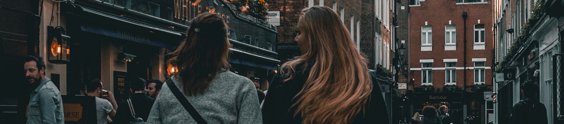 Two women walking down a busy street together Two women walking down a busy street together