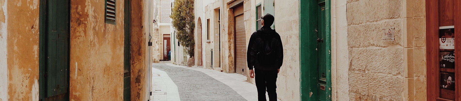 A man walking through a old street A man walking through a old street
