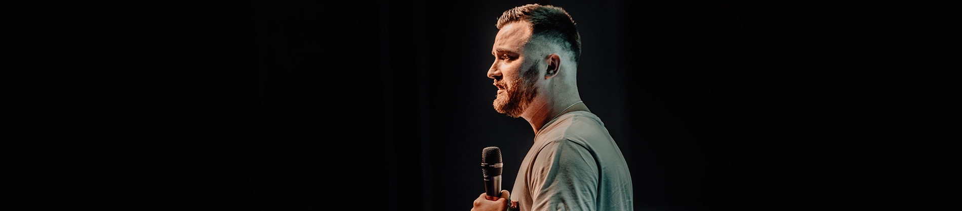 A preacher stood holding a microphone A preacher stood holding a microphone