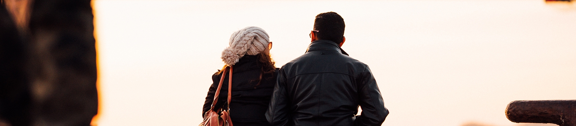 A man and woman sat together looking outwards A man and woman sat together looking outwards