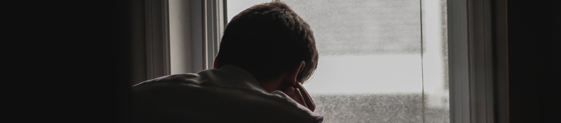 A man resting on his hand looking out the window A man resting on his hand looking out the window