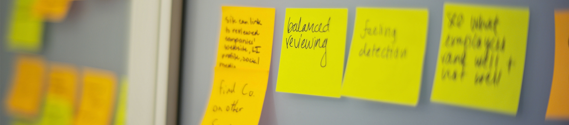 Yellow post-it notes on a board Yellow post-it notes on a board