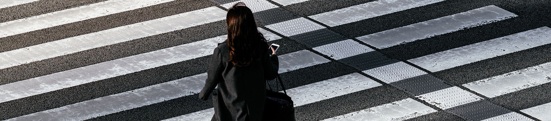 A women crossing a zebra crossing A women crossing a zebra crossing