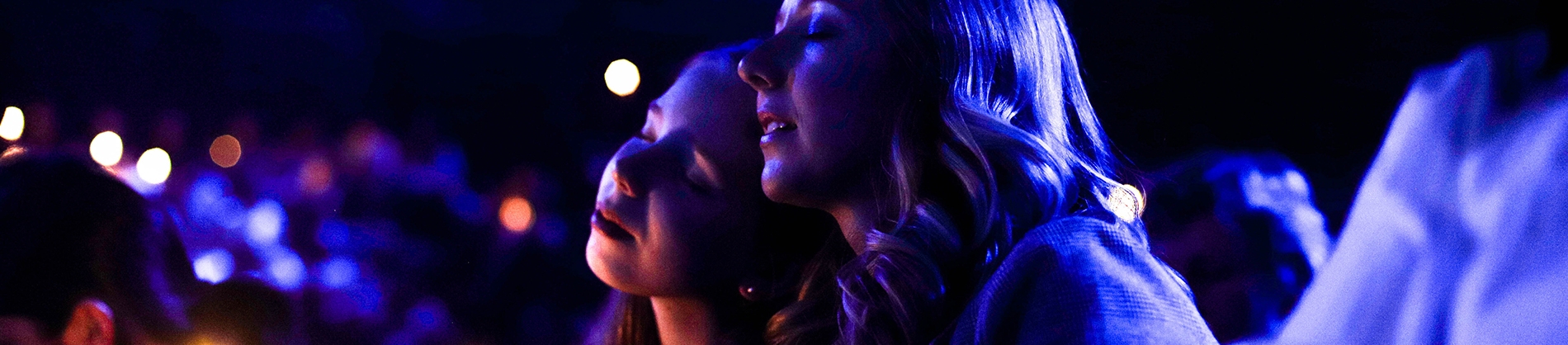 Two women with their eyes closed in worship Two women with their eyes closed in worship