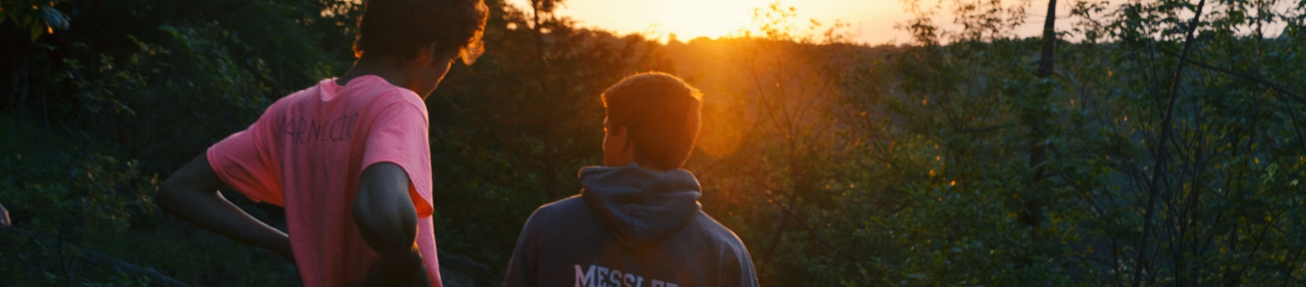 Two guys talking and looking towards the sunset Two guys talking and looking towards the sunset