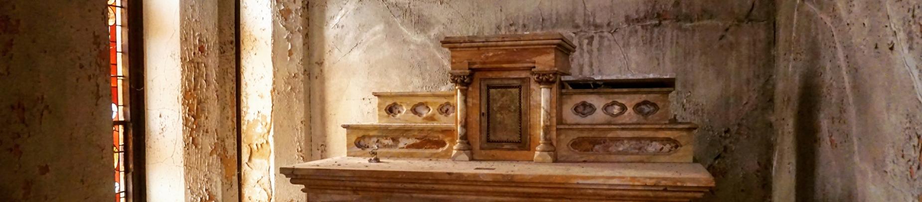 A wooden altar in a run down church room A wooden altar in a run down church room