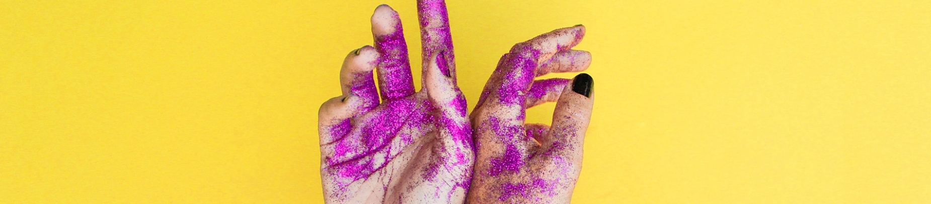 Women's hands with purple glitter on them Women's hands with purple glitter on them