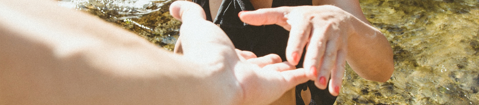 A man reaching out his hand to a women's hand A man reaching out his hand to a women's hand
