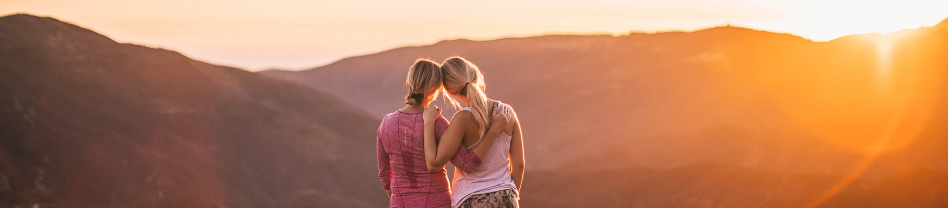 Two friends looking over a mountain range Two friends looking over a mountain range