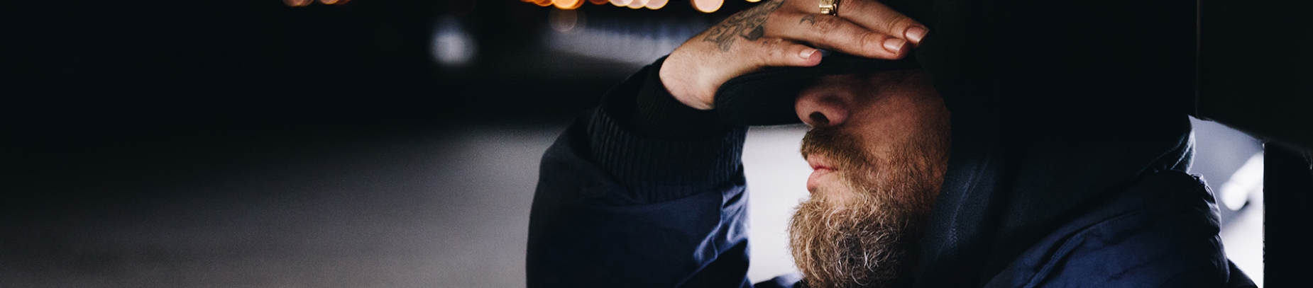 A man with his hand covering his eyes A man with his hand covering his eyes