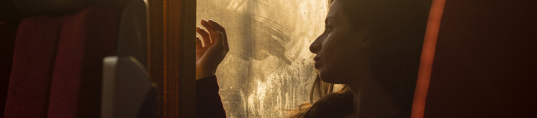 A women looking out of a window on a train A women looking out of a window on a train