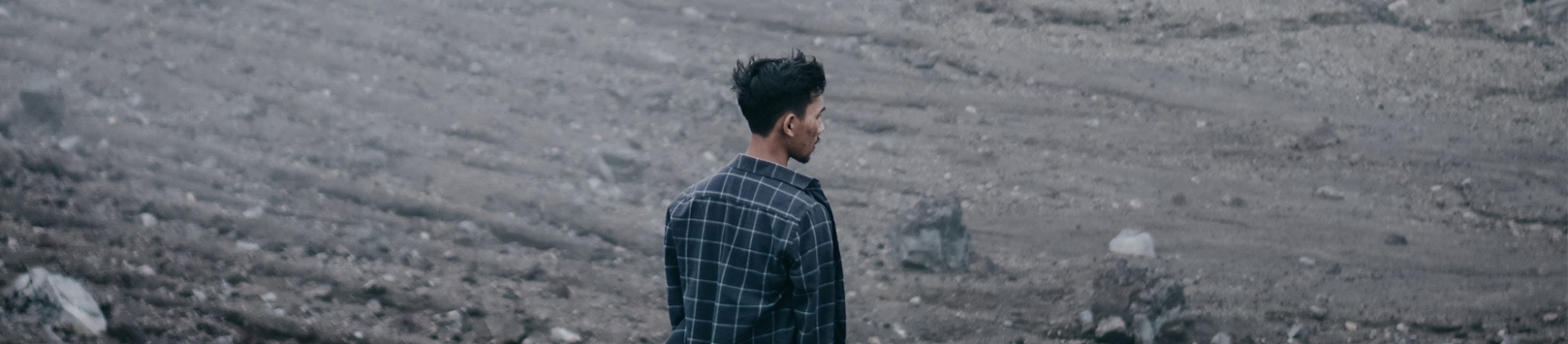 A guy stood in a rocky wasteland A guy stood in a rocky wasteland