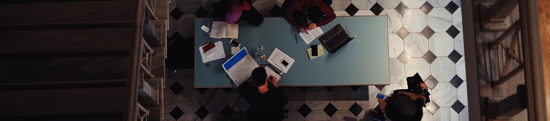 A group of people studying around a table A group of people studying around a table