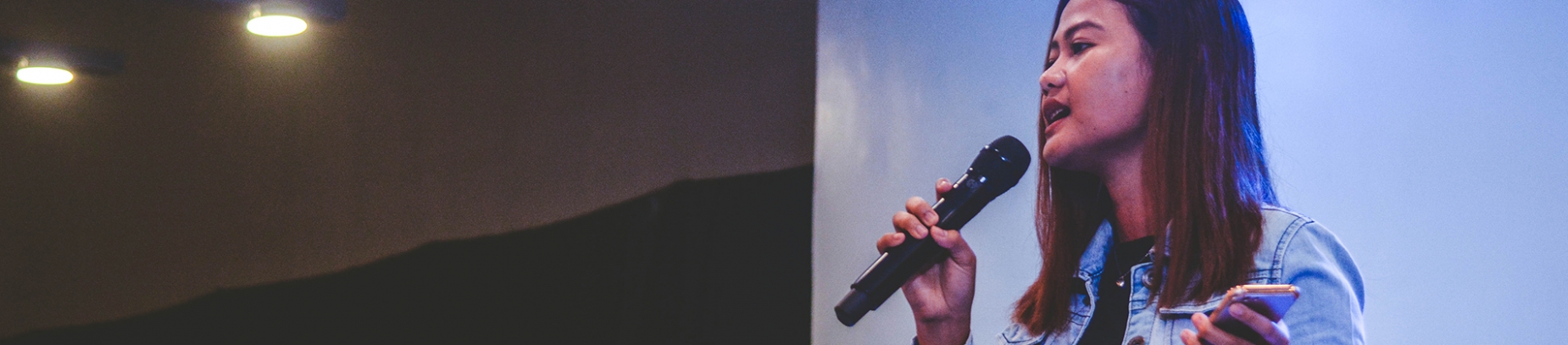 A women preaching into a microphone A women preaching into a microphone