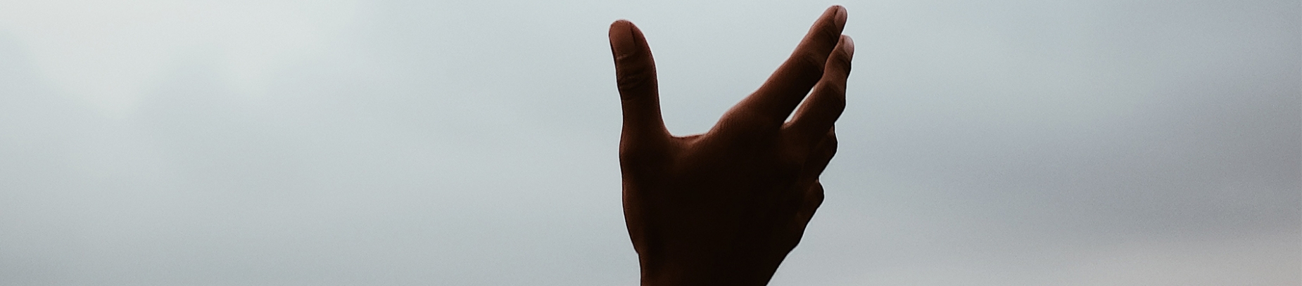 A persons hand open towards the sky A persons hand open towards the sky