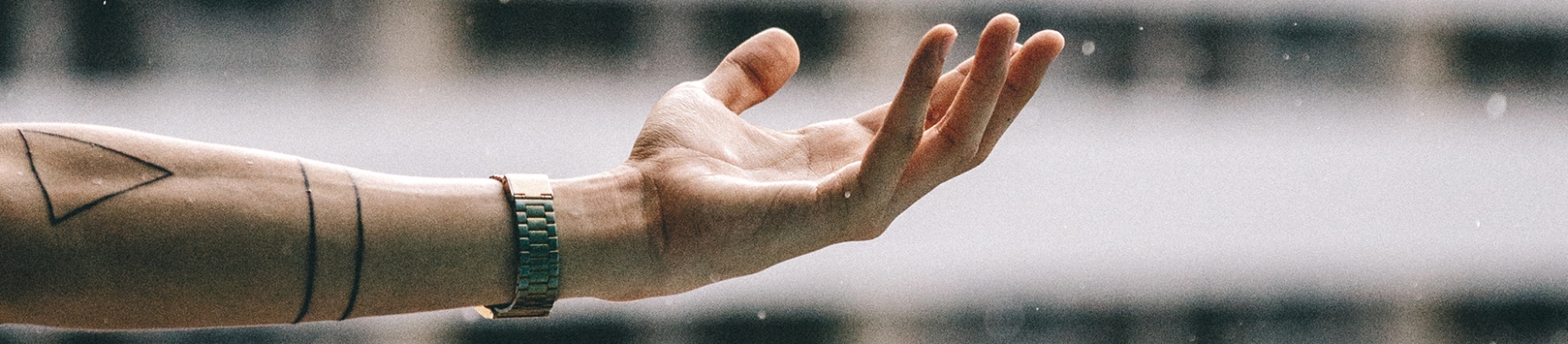 A guy holding his arm out with his hand facing upwards A guy holding his arm out with his hand facing upwards