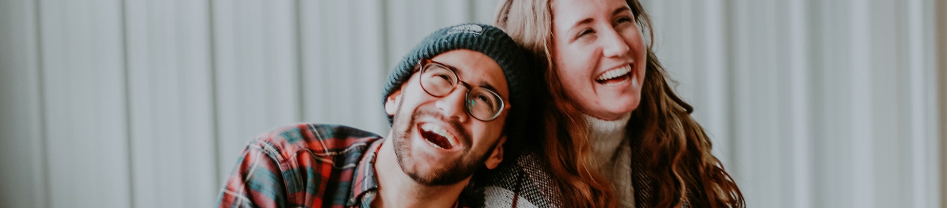 A man and women laughing together A man and women laughing together
