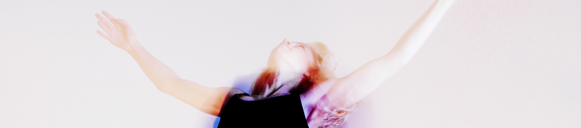 A distorted photo of a women jumping with her hands in the air A distorted photo of a women jumping with her hands in the air