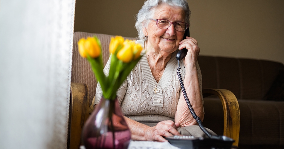 Women smiling while on the phone Women smiling while on the phone